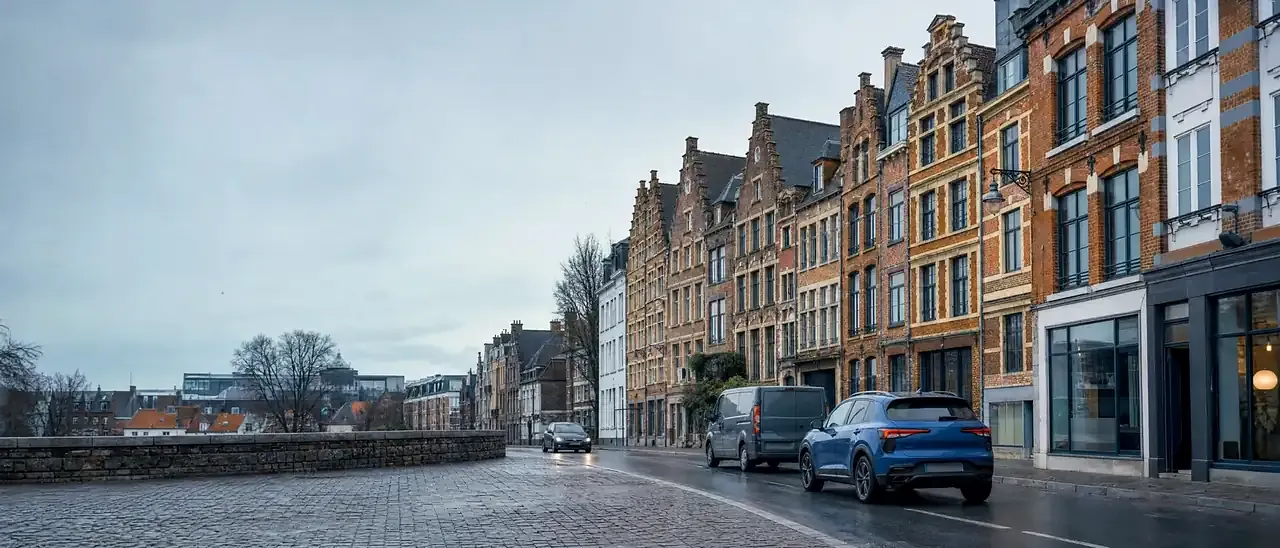 Circulation dans une rue de Lille devant des façades flamandes en brique
